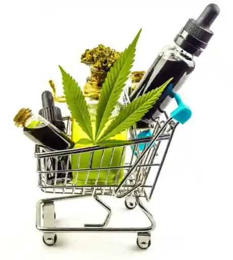 Cannabis flower, oil dropper bottles, and a leaf in a miniature shopping cart.
